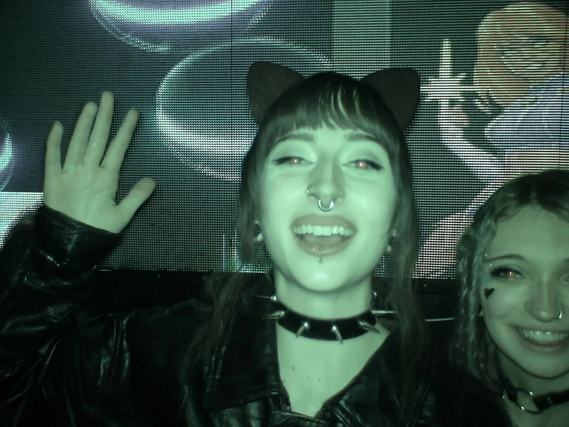 Smiling girl in cat ears and a spiked choker