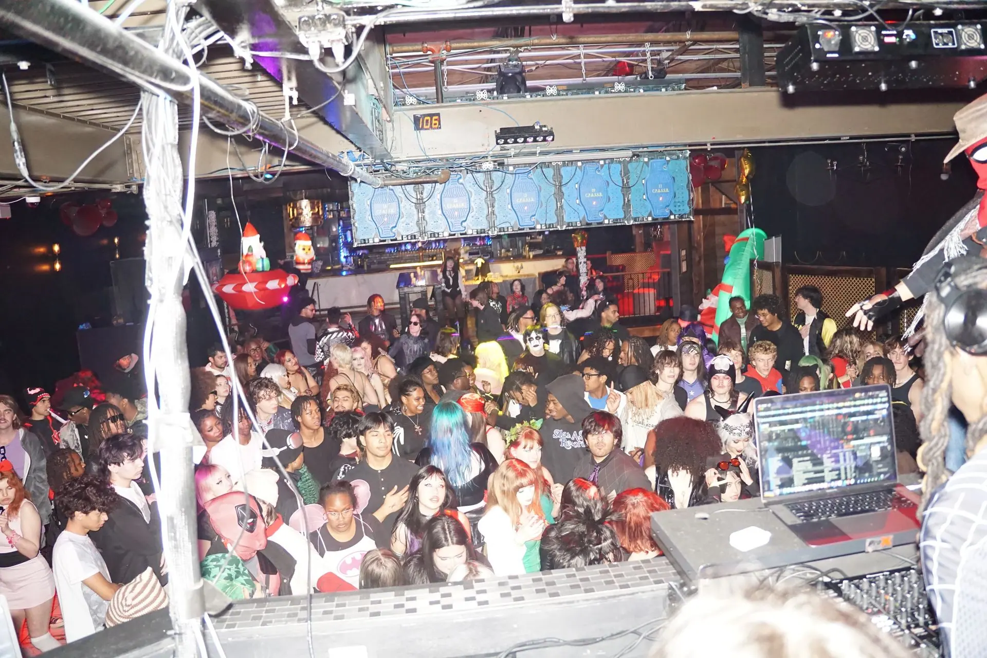 View from the DJ booth over a packed crowd in costume