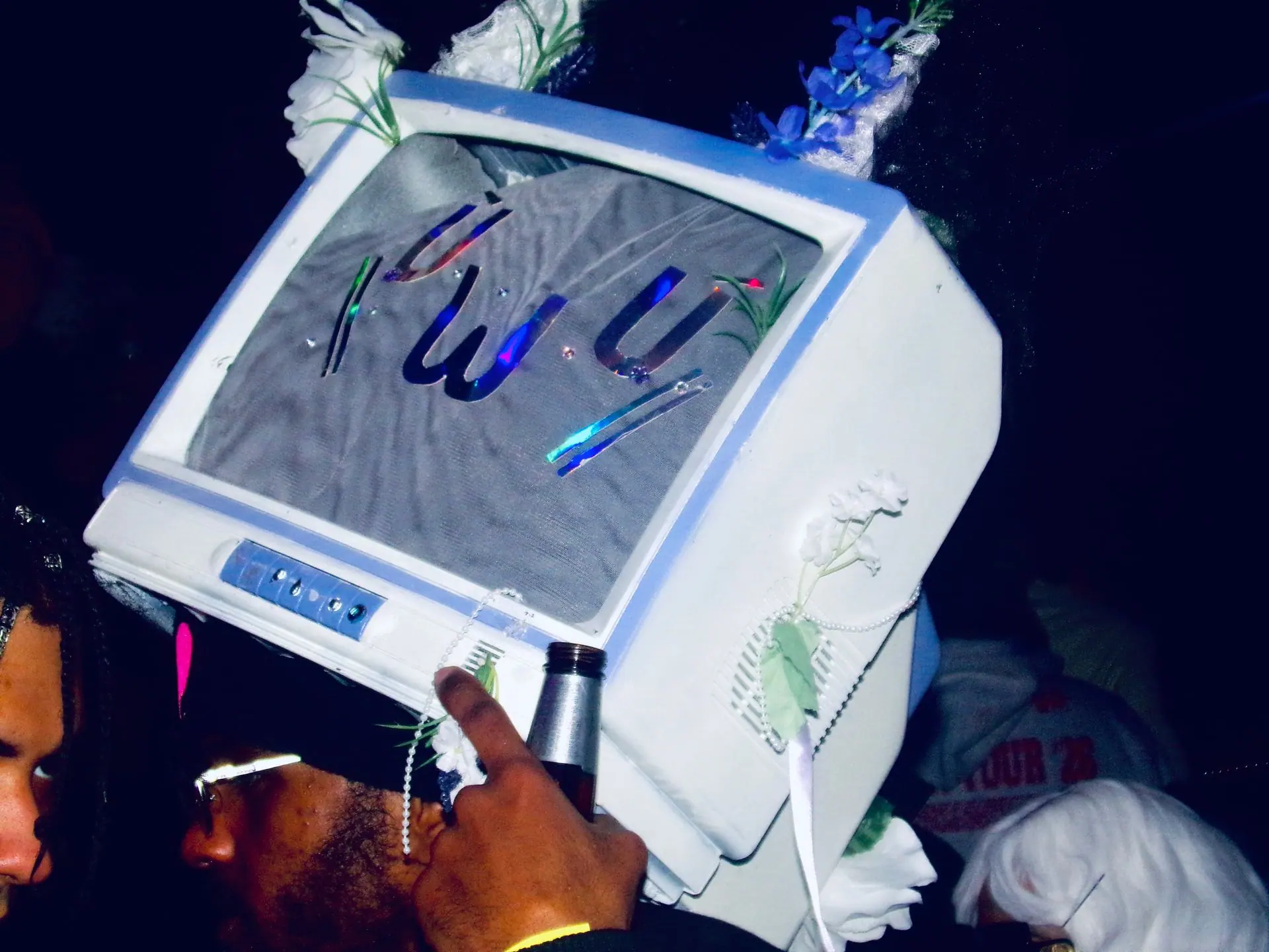 Someone wearing an old computer monitor as a mask