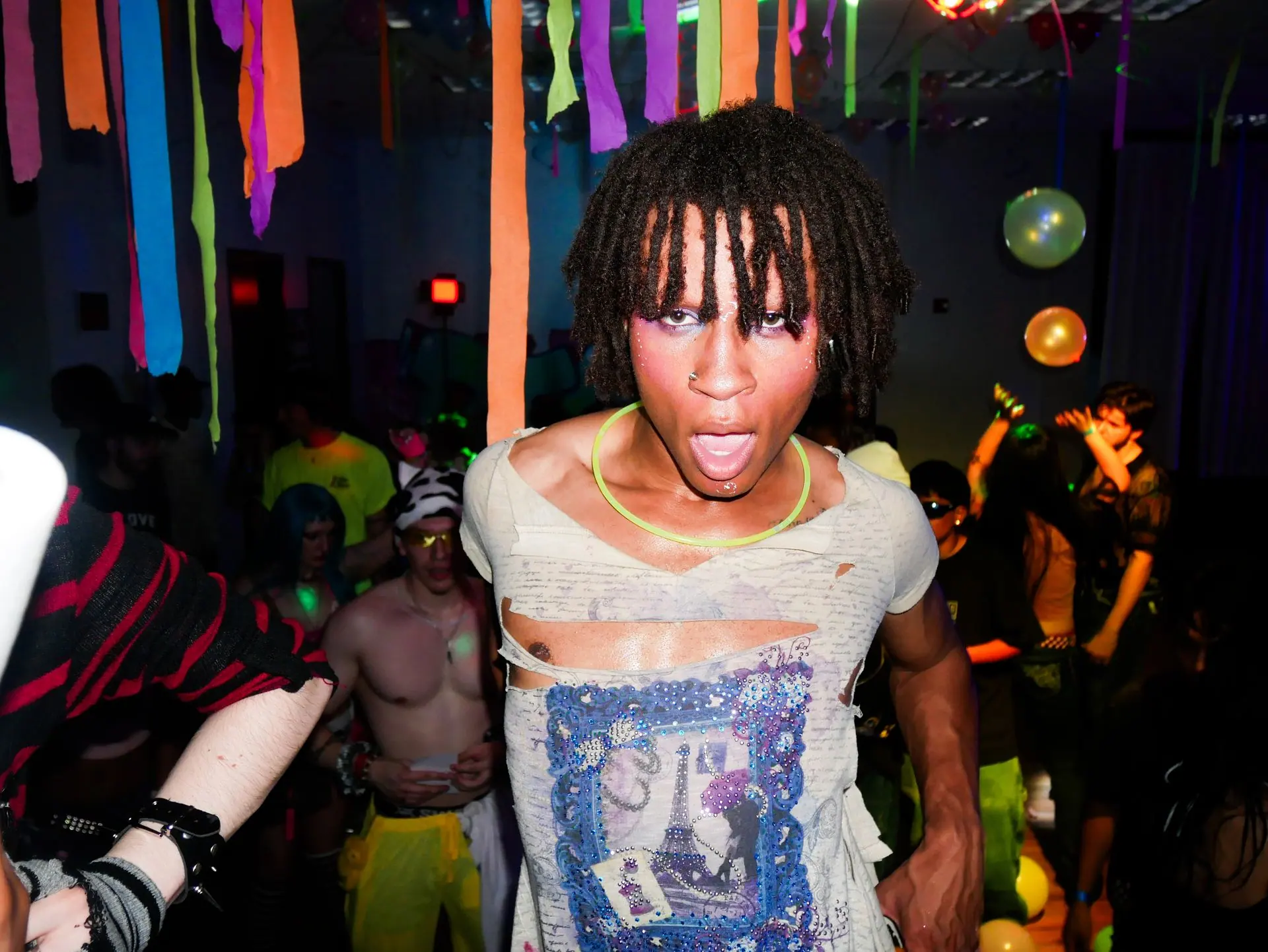 Dancer in a torn shirt yelling at the camera