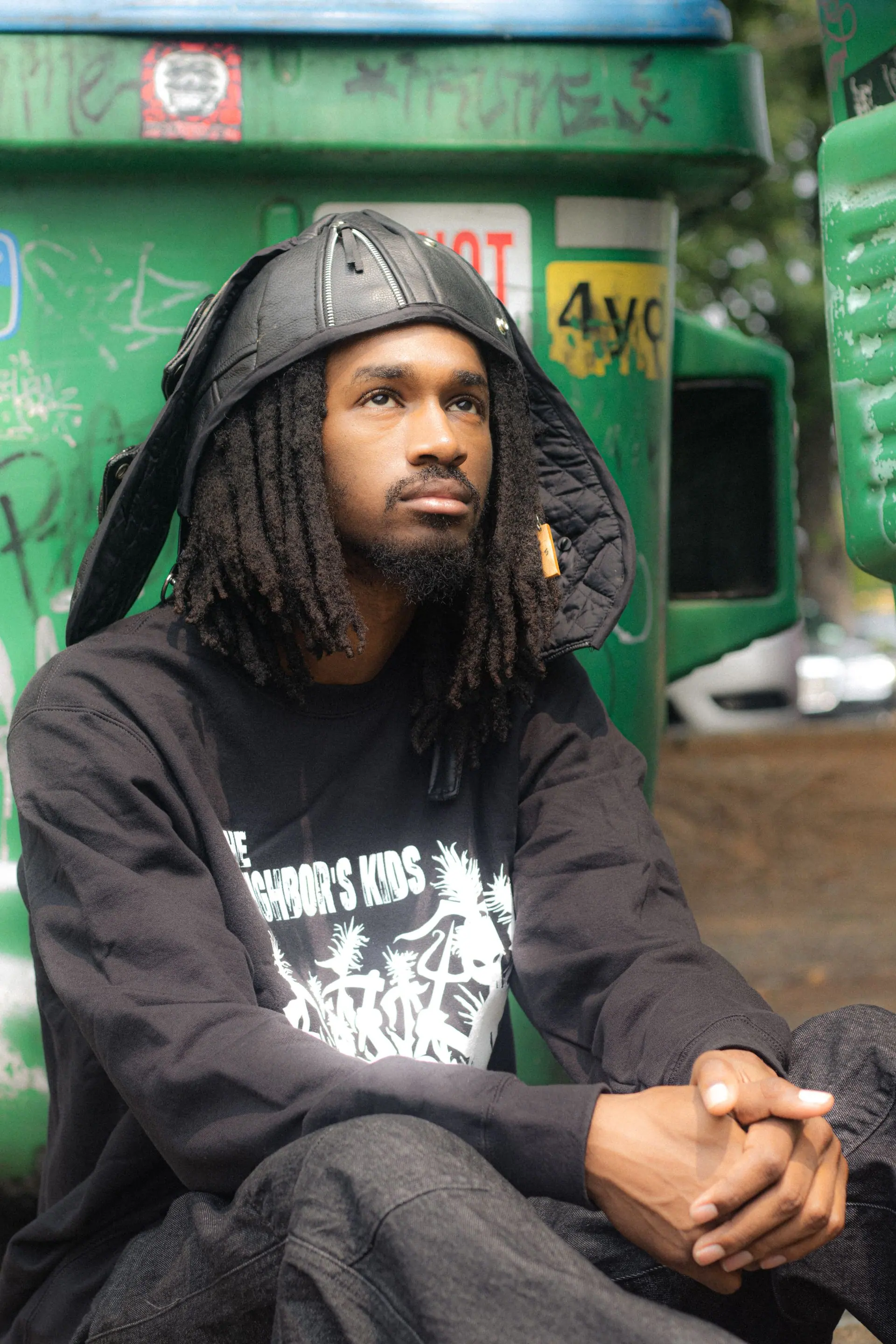 Model in a black logo crewneck on the street